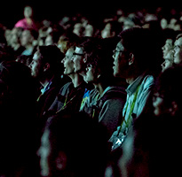 Smiling SIGGRAPH attendees in a theater.
