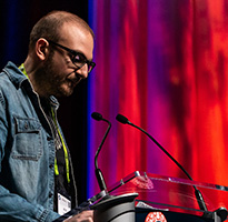 SIGGRAPH presenter speaks at a session podium.