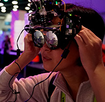 SIGGRAPH attendee trying on a headset with mirrored lenses.