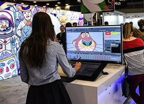 SIGGRAPH attendee animating a character on a computer screen.
